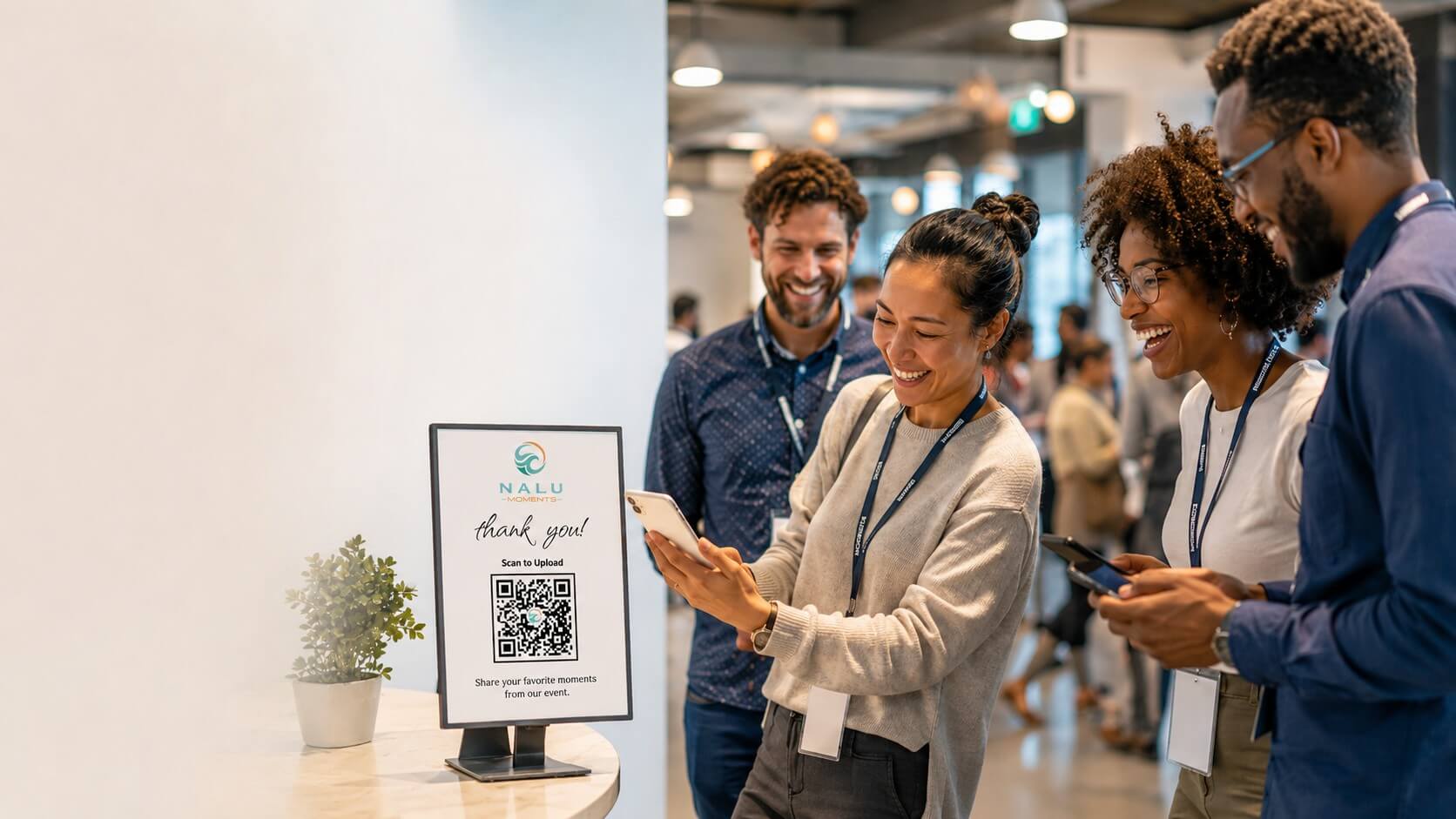 Employees at a team-building event scanning a QR code to upload photos and videos